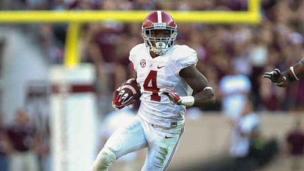 Oct 17, 2015; College Station, TX, USA; Alabama Crimson Tide defensive back Eddie Jackson (4) makes an interception during the third quarter against the Texas A&M Aggies at Kyle Field. The Crimson Tide defeated the Aggies 41-23. Mandatory Credit: Troy Taormina-USA TODAY Sports